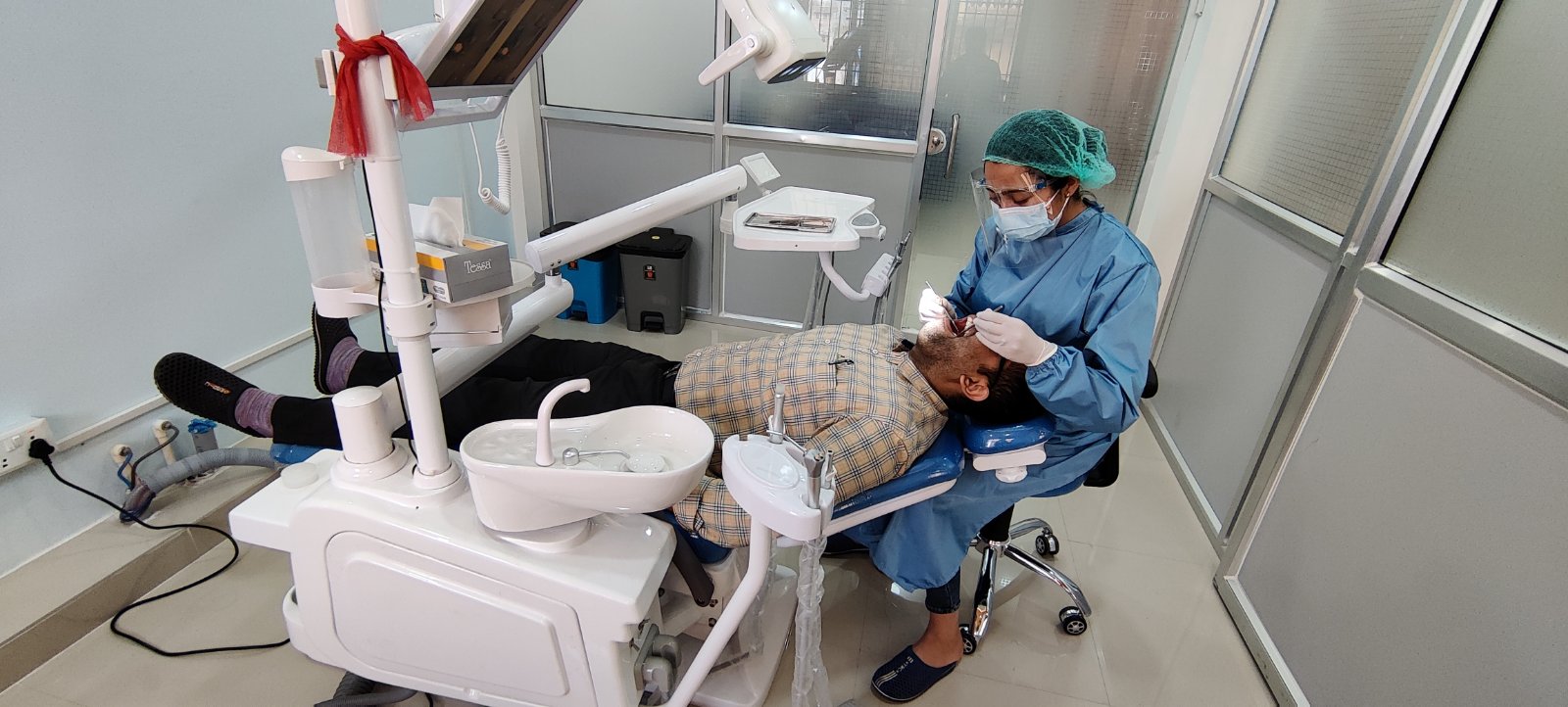 Doctor treating patient at Dentosmile